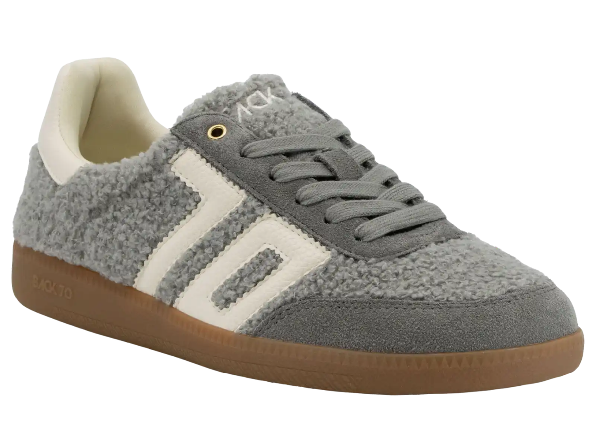 A gray fuzzy suede sneaker with off-white side stripes, gray laces, and a brown gum sole, shown on a plain white background.