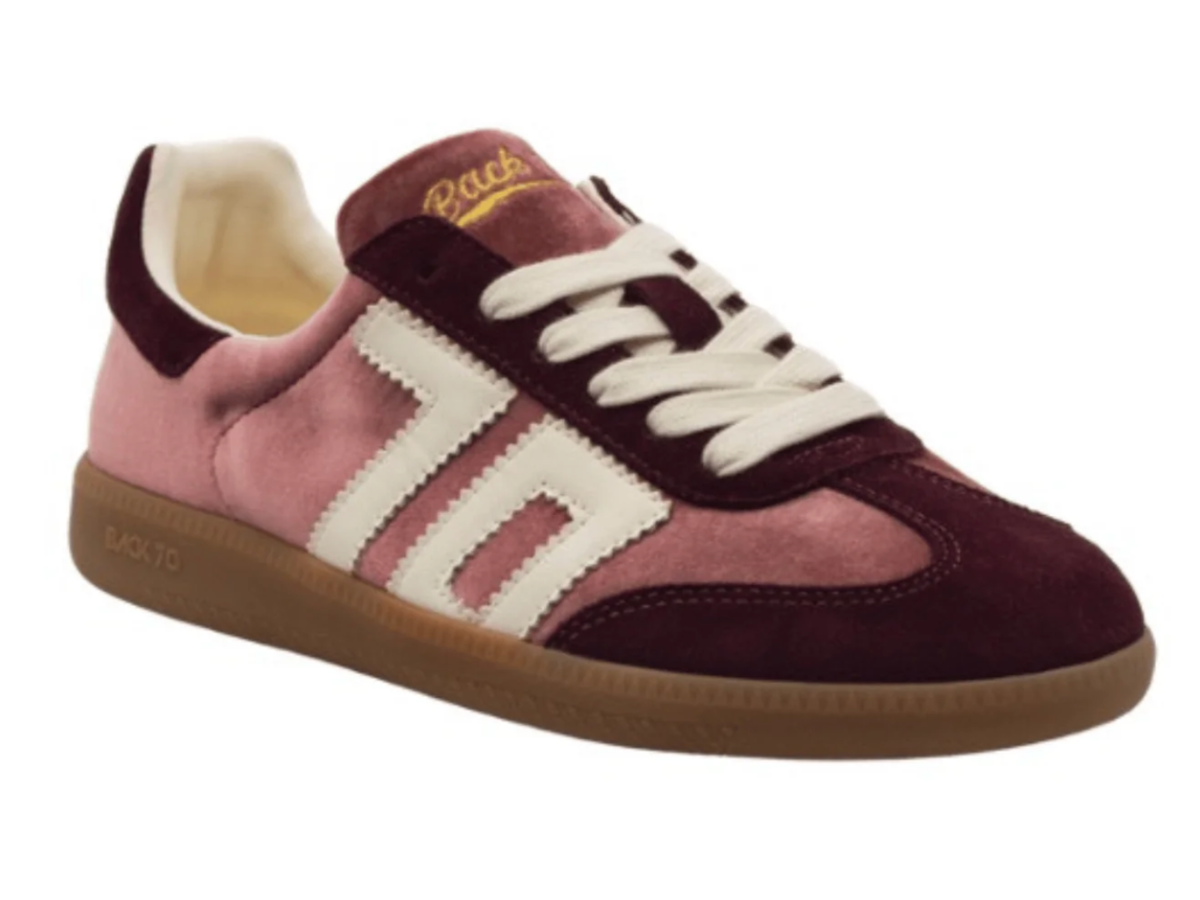 A low-top sneaker by Backto10 featuring dusty pink suede, deep burgundy suede panels, cream-colored side stripes, white laces, and a brown gum sole.