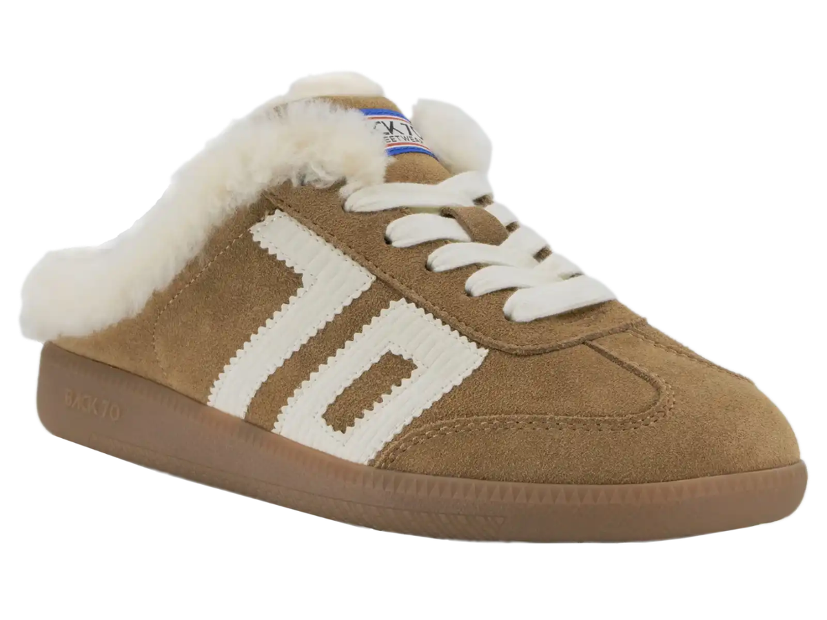 A tan suede slip-on sneaker with white faux-fur lining, white laces, and a white side stripe design, shown on a plain white background.