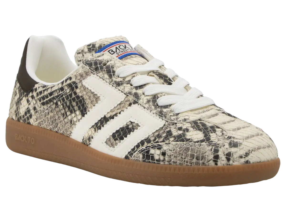 A low-top sneaker by Back To School featuring a beige and black snakeskin pattern, white laces, a white side stripe design, and a brown gum sole.