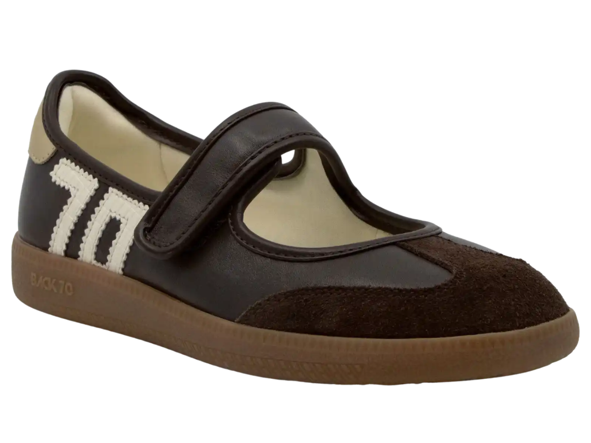 A dark brown and black Mary Jane style shoe with a hook-and-loop strap, a white and black striped '70' on the side, and a brown sole, shown against a plain white background.