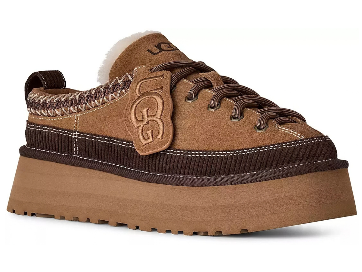 A brown suede and dark brown ribbed knit platform sneaker by UGG, featuring a thick tan sole, dark brown laces, a tan leather UGG logo patch on the side, and a white faux-fur collar, shown against a plain white background.