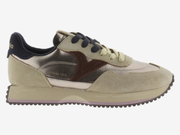 A low-top sneaker shown in profile against a light gray background. The shoe features a mix of beige suede, metallic silver mesh, dark brown overlays, and navy blue accents on the collar and laces.