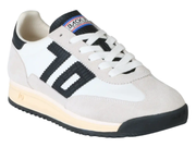 A low-top sneaker with a white and light beige suede upper, featuring a prominent black three-stripe design on the side, white laces, and a black and beige sole.