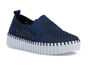 A navy blue slip-on platform sneaker with a perforated upper and a thick white ridged sole, shown from a three-quarters angle on a white background.