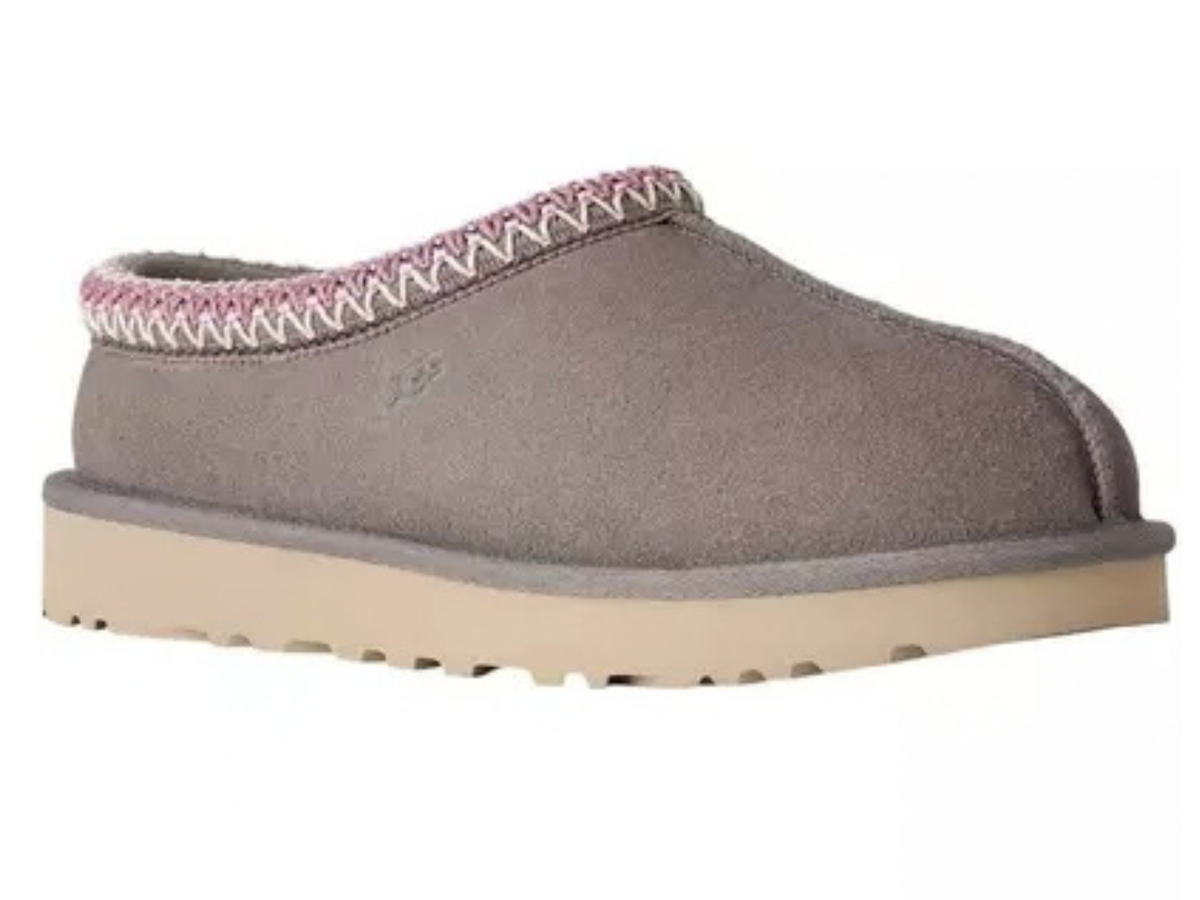 A single taupe-brown suede slipper with a pink and white zigzag knit trim around the collar and a beige sole, shown against a plain white background.