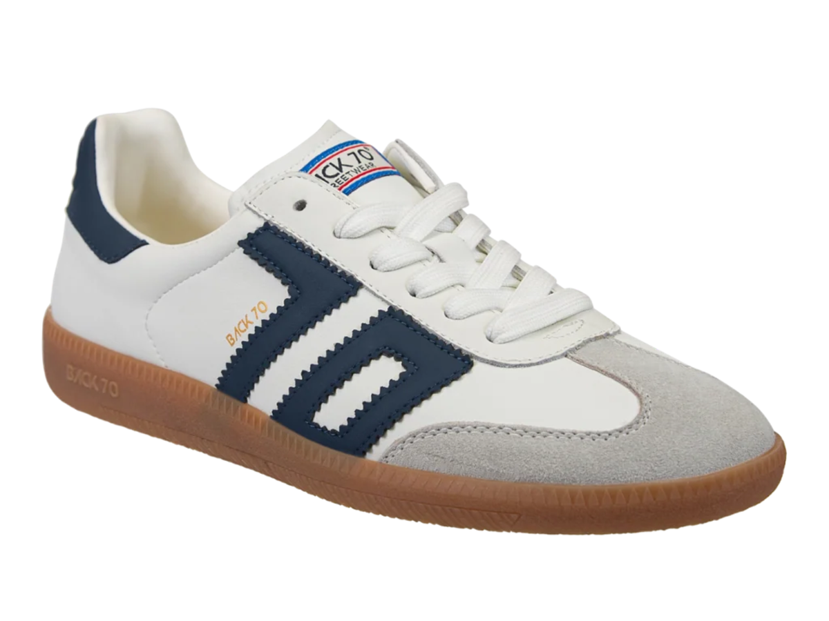 A low-top Sockto sneaker in white, navy blue, and light gray suede, featuring a brown gum sole, shown against a plain white background.