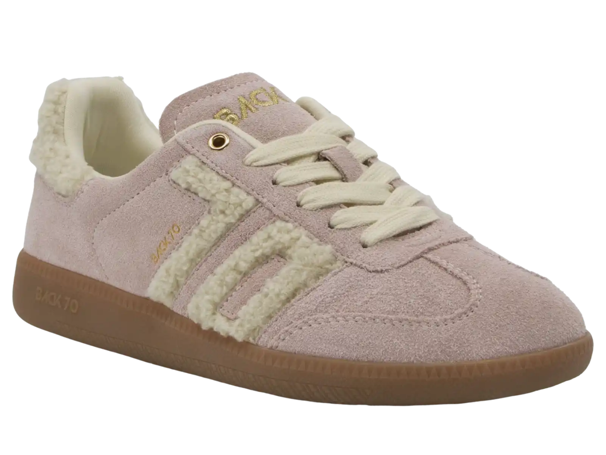 A light pink suede sneaker with cream sherpa fleece side stripes, cream laces, a cream collar lining, and a brown gum sole. The brand name 'BAGS' is printed in gold on the tongue and side.