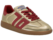 A metallic gold low-top sneaker with red accents, including the side stripes, laces, and heel tab, on a white background.
